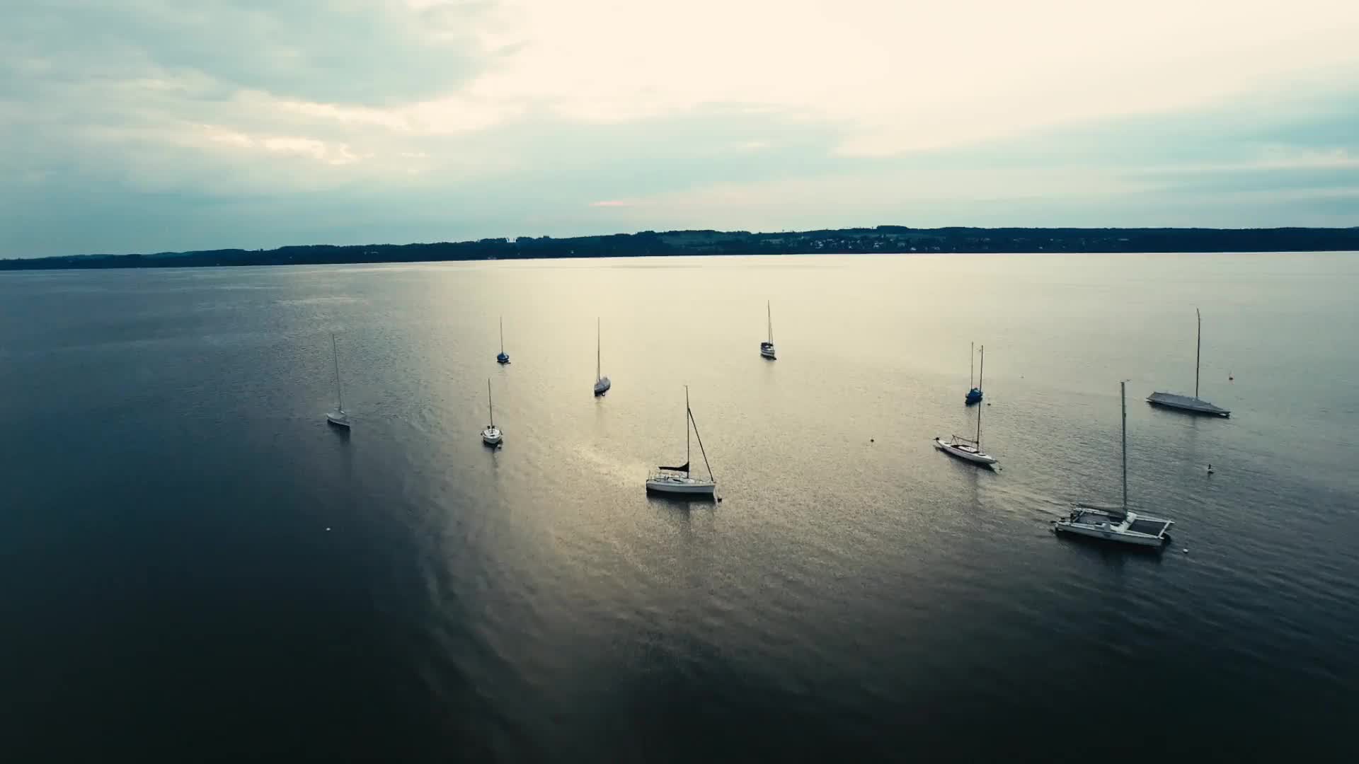 A group of boats floating on top of water.